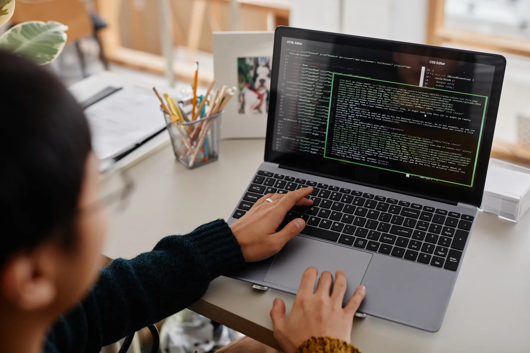 Close-up of a laptop displaying code and technical data